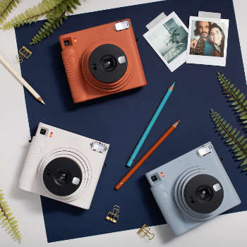 instax sq1 instant camera all colors on a table